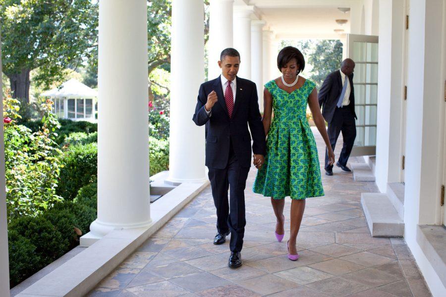President Barack Obama and First Lady Michelle Obama walk along the Colonnade of the White House.