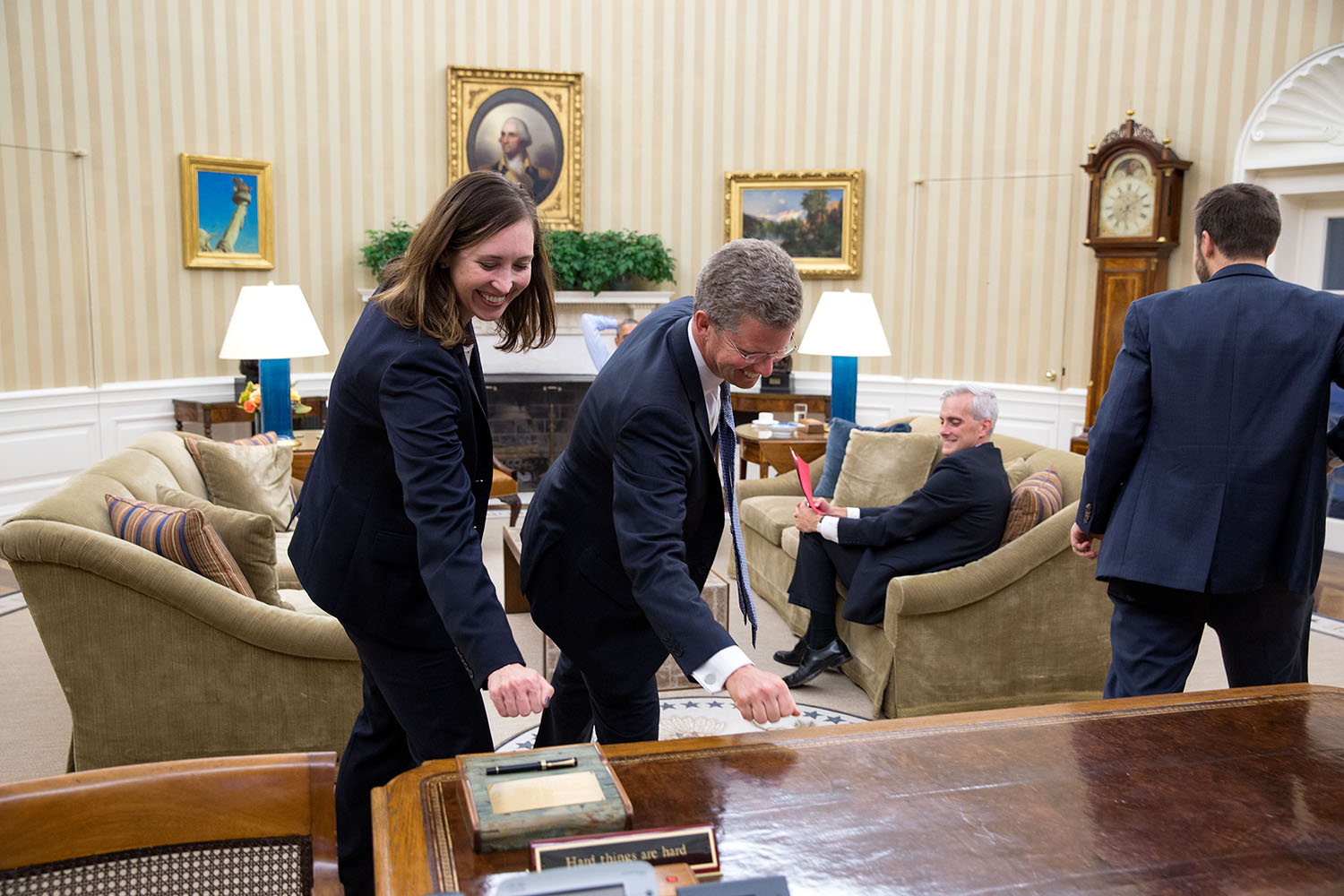 After their meeting with the President, Katie Beirne Fallon, Director of Legislative Affairs, and Shaun Donovan, Director Office of Management and Budget, knock on wood–the Resolute Desk–in hopes that the budget would pass through Congress.