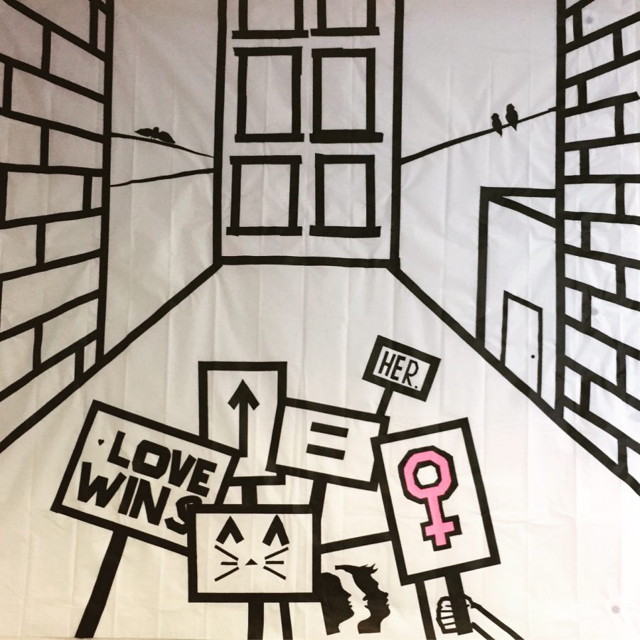 Womens March Mural created by Seniors Julianne Sackett, Shannon Damiano and Delia Noone.