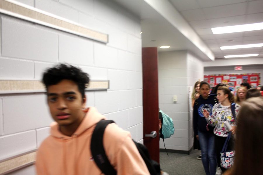 Students from CHS rush from class to class on the second floor. At the left of the frame is Junior Parthesh Patel, who hails from Freehold.