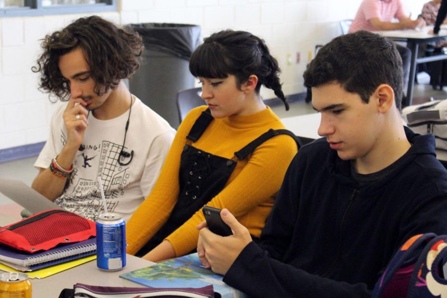 The trio of friends sit on one side of the lunch table together talking, sitting on their phones and eating cheese sticks. Junior Mason Grigo, right, of Millstone is a third wheel of couple Jackie Siminerio, middle, of Manalapan and Luca Montana, left, of Holmdel, but doesn’t seem to mind.