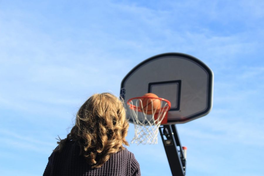 During a brief basketball pickup game, junior Greer Shanley of Fair Haven shoots hoops with math teacher Scott Stengele.