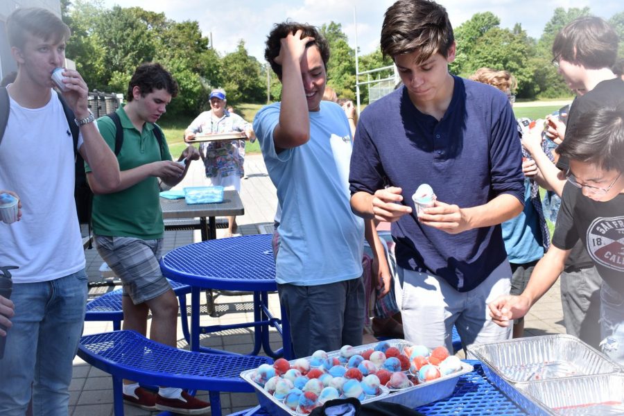 Senior and SGA president Liam Marshall of Sea Girt, center, and junior and SGA member Dane Tedder of Ocean, right, hand out Italian ices on the first day of school.