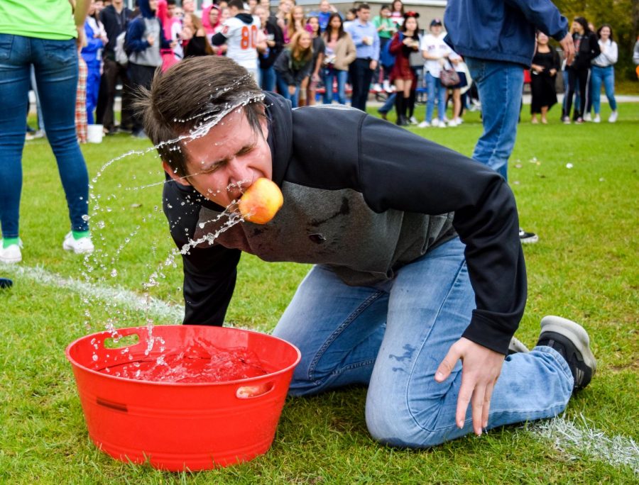 Fall Spirit Week 2018 began on Monday, Oct. 29 with Character Day and the fall-themed relay competition. The event took place on the back patio due to some events being impractical for taking place indoors. Senior Michael Topper of Ocean competes in the apple bobbing portion of the competition.