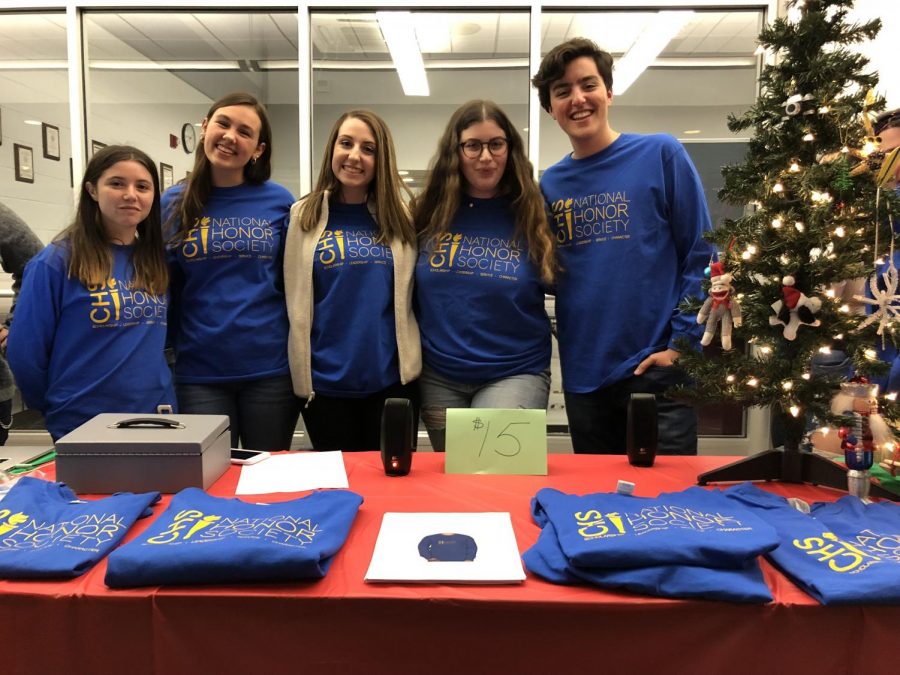 Seniors and NHS members, from left, Emma Farkas of Colts Neck, treasurer Allie Beekman of Neptune, president Jules Andersen of Howell, secretary Tali Petto of Marlboro and Liam Marshall of Sea Girt represented the National Honor Society (NHS) at Mingle & Jingle. NHS sold t-shirts and played Christmas music at the event.