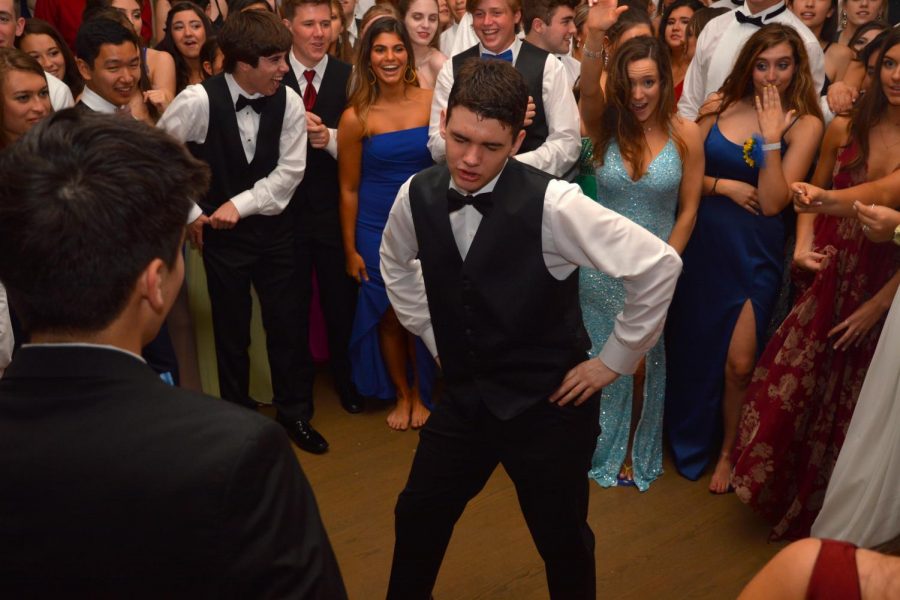 Junior Vaughn Battista of Tinton Falls dances in the center of a student-formed circle during the prom.