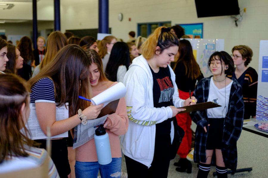 Students sign up for clubs that had stands in the cafeteria on Friday the 13th.