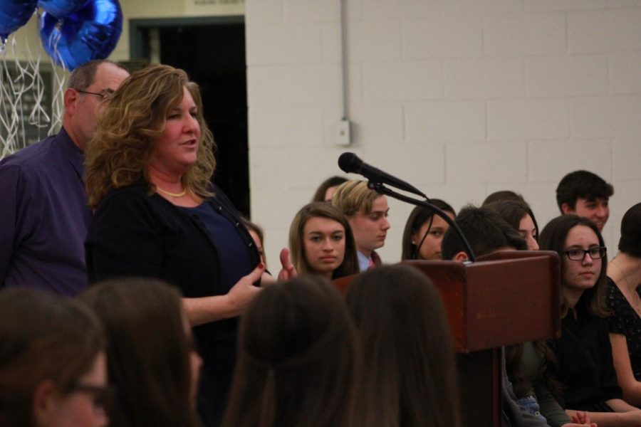With NHS inductions right around the corner (last year's ceremony pictured above), students discuss the changes in the NHS applications.