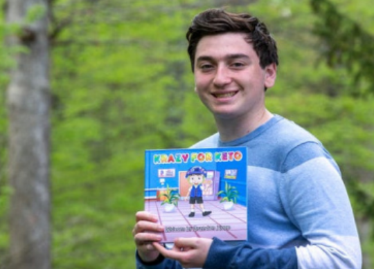 Brandon Kopp poses with his self published book, “Krazy for Keto.”