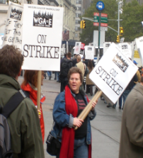 Film writers protest for better wages in the streets of New
York City. ”Wall Street writers strike.” by kona99 is licensed
under CC BY-SA 2.0.