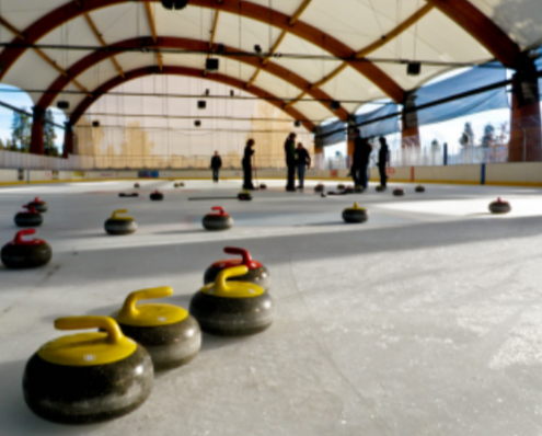Curling consits of teams facing off to score points by trying to get their stones as close to the “tee.” “Curling Stones” by ex_magician is licensed under CC BY 2.0.