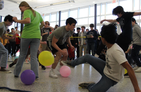 Students battle it out in the balloon pop arena.
