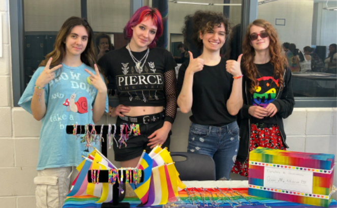 Members of the Queer Alliance sell merchandise and decorate sidewalks with chalk to celebrate Pride Week May 28 to 31.