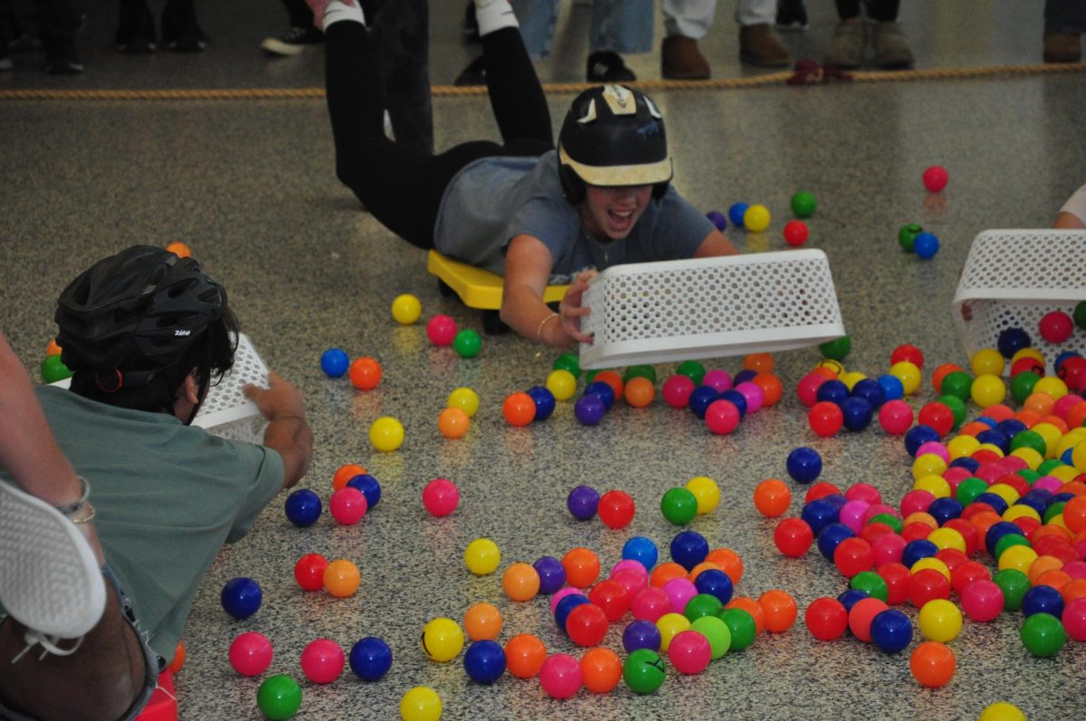 Students compete in a game of Hungry Hungry Hippos to secure fall spirit week points.


