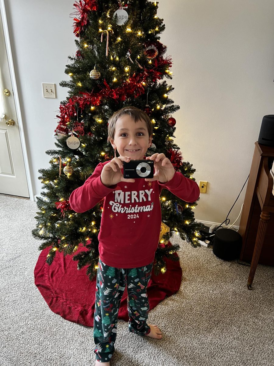 Xander Walls poses with his new digital camera, donated by the CHS NHS, on Dec. 25, 2024.