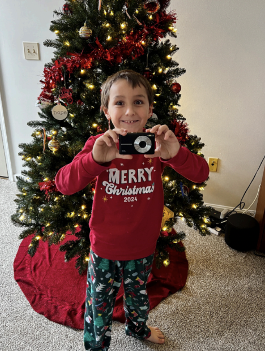 Xander Walls poses with his new digital camera, donated by the CHS NHS, on Dec. 25, 2024.