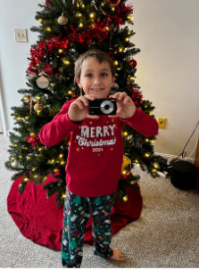 Xander Walls poses with his new digital camera, donated by the CHS NHS, on Dec. 25, 2024.