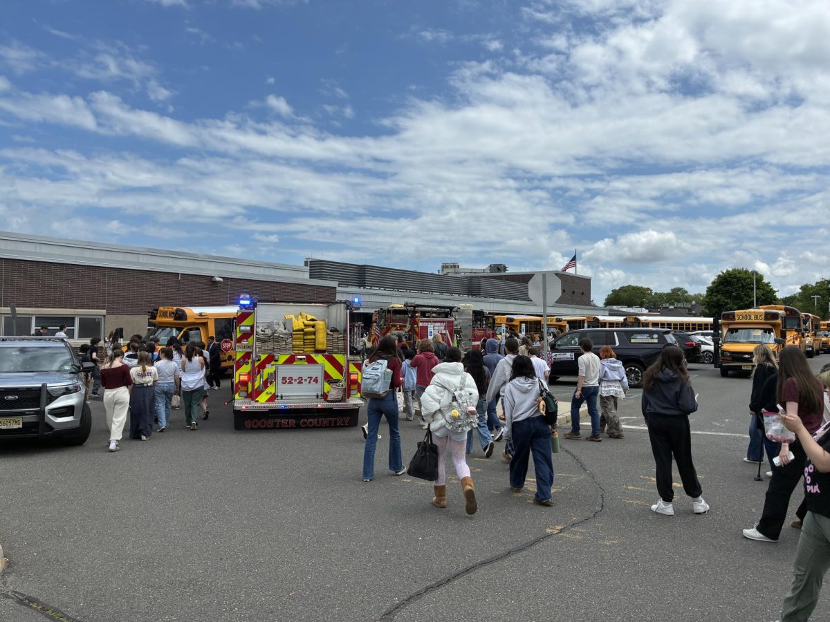 Communications High School students re-enter the building after evacuating when a chemistry lab set off the newly installed fire alarm system.