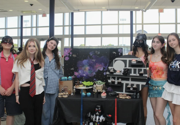 Freshman stand around their winning cupcake wars display. 